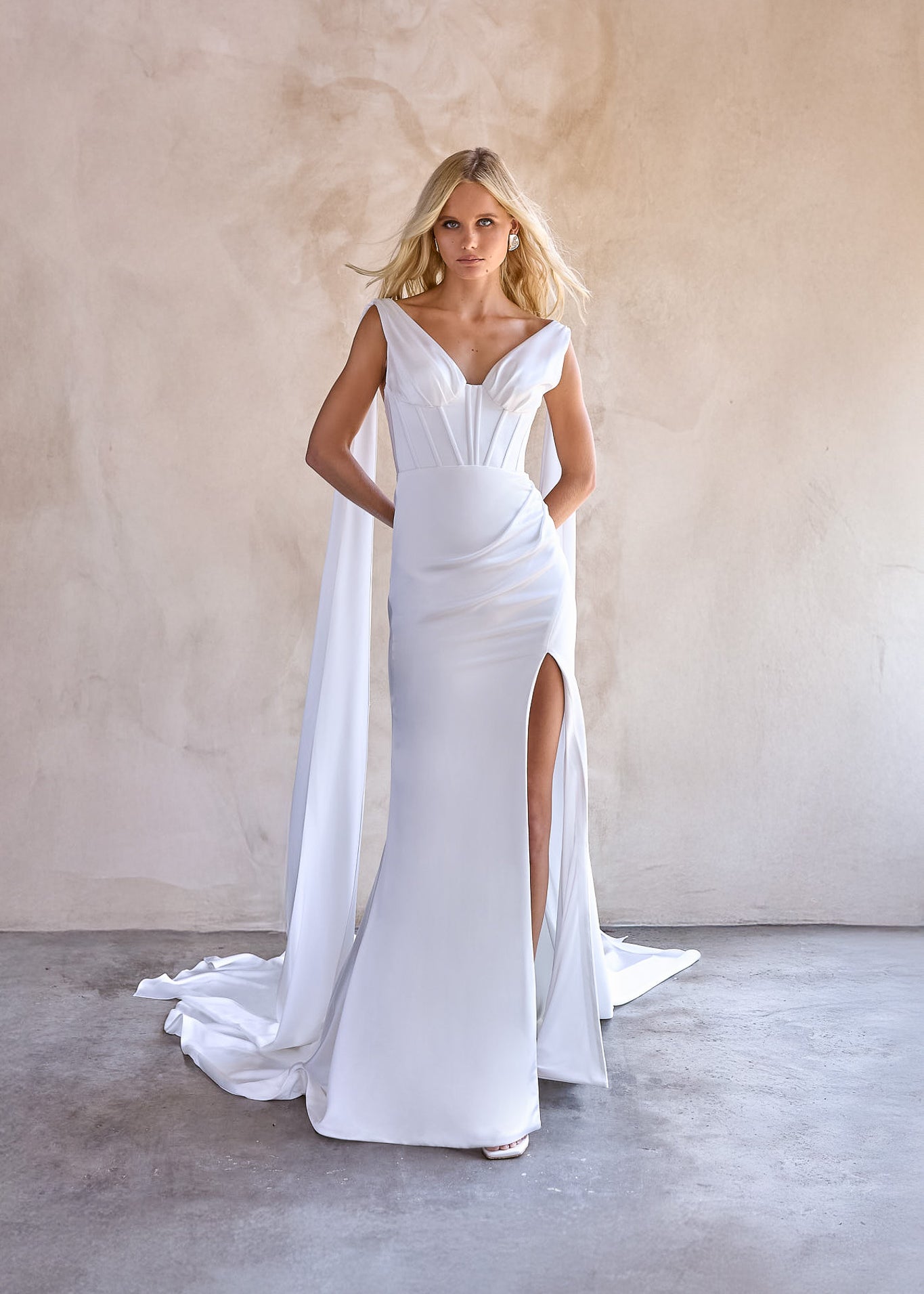 Jani satin wedding dress by the bryde. exposed boning bodice with thigh high split and satin wings